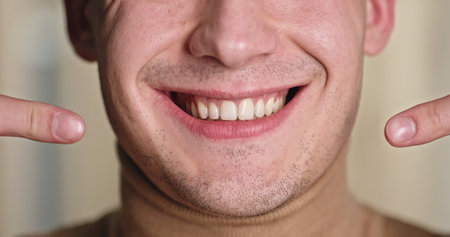 Joyful Smile: Young Man Showcasing Healthy Teeth