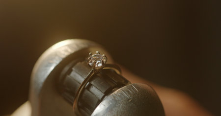 Crop blacksmith making diamond ring in workshop