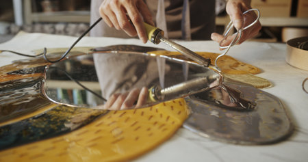 Glass Artist Soldering a Floral Mirror in Creative Studio
