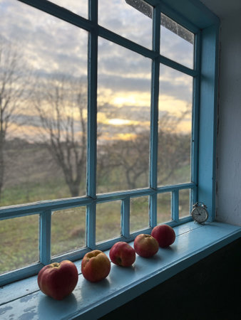 Apples placed on a beautiful Windowsill adorned at the enchanting time of Sunset