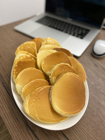 Delicious and Warm Homemade Pancakes Served on an Elegant Platter for Everyone to Enjoy