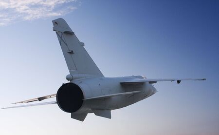 a fighter flying, seen from behind