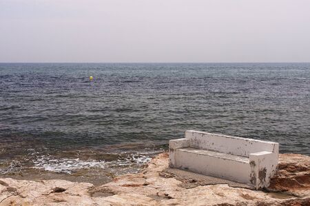 peaceful bench in torrevieja coastline, in spainの写真素材