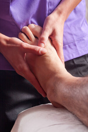 a man is receiving a massage in a footの写真素材