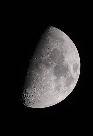 Moon in the first quarter as can be seen by telescopeの写真素材