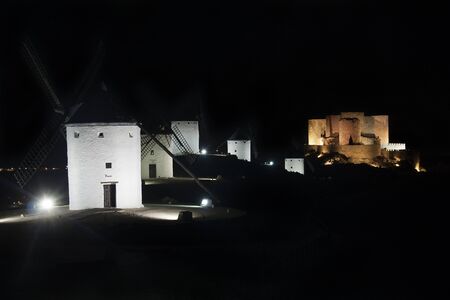 night view of traditional spanish windmills in consuegra, toledoの写真素材