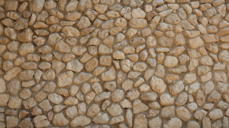 Pebble in concrete Wall. Stone background. Stone paving surface. Natural outdoor decor material...