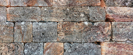 Old Stone Wall Cracked Bricks Weathered Texture. Ancient Brickwork. Distressed Surface. Background Backdrop. Wide Panoramic Photoの写真素材