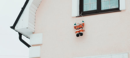 Santa Claus figurine is hanging on the window.の写真素材