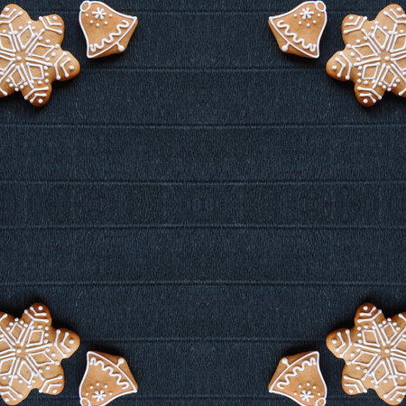Gingerbread and Christmas tree branches on a dark paper craft background. Happy New Year Conception