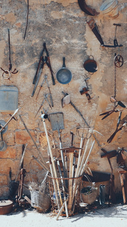 Old rusty utensils decorate the wall. Vintage Wallpaper