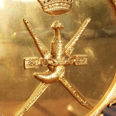 Regal Gold Shield with Emblematic Sword and Crown. A Symbol of Royalty and Chivalry in Gleaming Metalwork. Oman, Muscatの写真素材