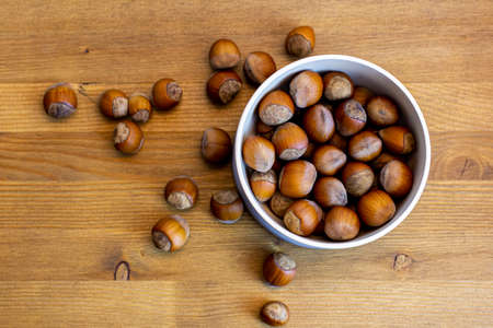 Nuts in the bowl on wooden tableの写真素材