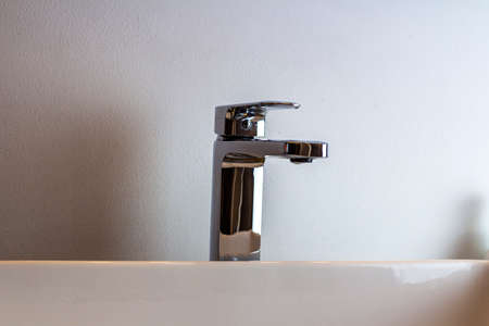 Minimalist bathroom with sink and wooden tableの写真素材