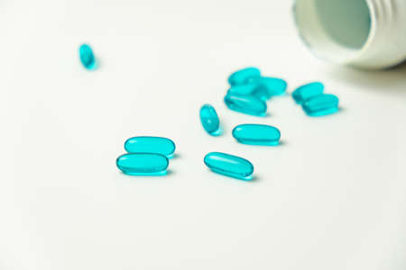 Blue pills isoalted on white background. side view