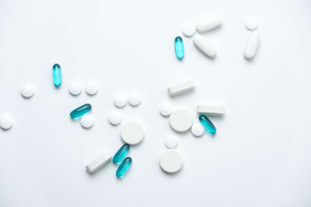 white and blue pills isolated on white backgroundの写真素材