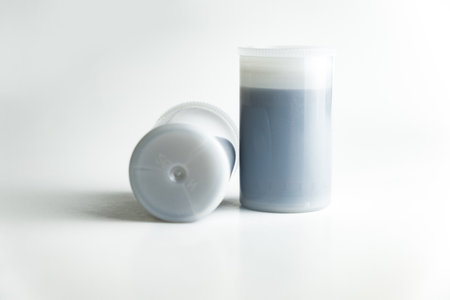 White 35 mm film canisters on whiteの写真素材