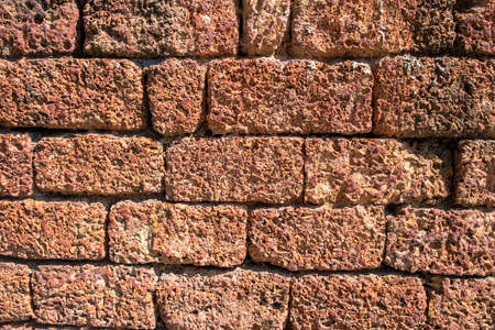 Old brick wall background, brick wall texture, structure. old broken brick, cement joints, close-up. crumbling from old age. construction, repair. concept of devastation, decline. high quality photoの写真素材
