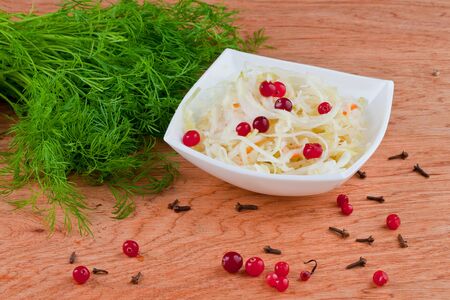 sauerkraut on wooden backgroundの写真素材