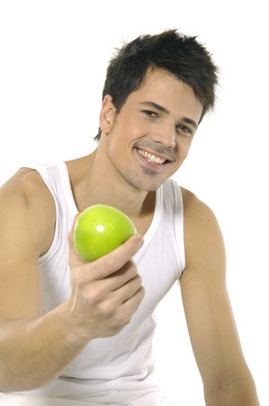 young man holds green appleの写真素材