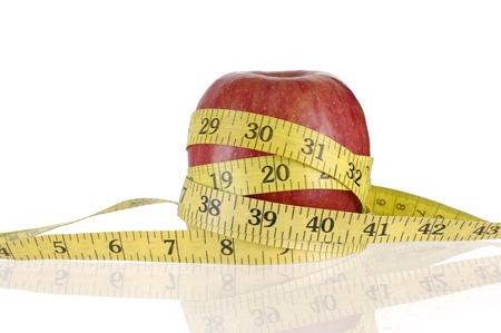 an apple with a measuring tape around it.の写真素材