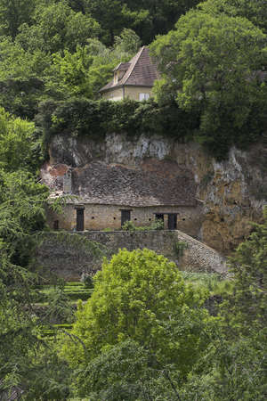 House carved in cliffs near the Dordogne River in Franceの写真素材