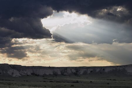 Crepuscular rays light up the bluffs of Pawnee National Grassland in Colorado.の写真素材