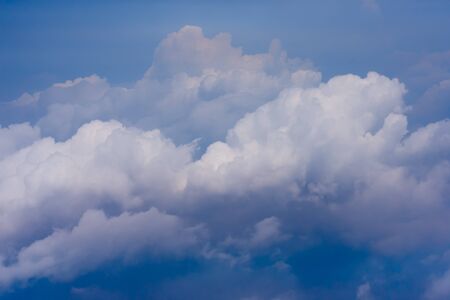 White cloud above the blue sky from airplane window.