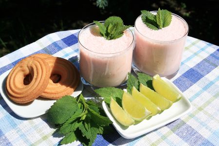 Strawberry milk shakes with green leaves of sageの写真素材