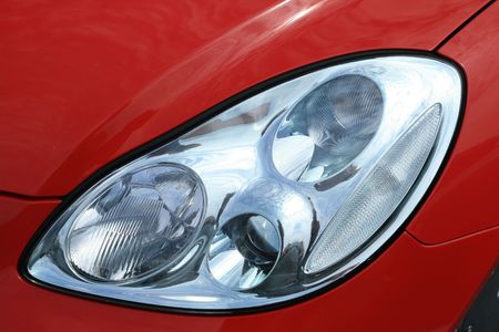 Beautiful, new and shiny car with red paint. Sporty automobile.