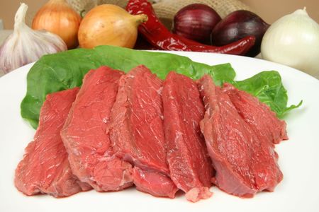 Fresh, raw beef meat prepared to be fried. Cuisine image.