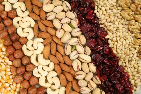 Nuts and corn - hazelnuts, cashews, almonds, pistachios, dried cranberry and walnuts background. Dry food. Nuts and corn - hazelnuts, cashews, almonds, pistachios, dried cranberry and walnuts background. Dry food.