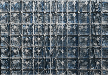 Workers paining a steel greenhouse structure under constructionの写真素材