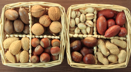 Varieties of nuts: peanuts, hazelnuts, chestnuts, walnuts, cashews, pistachio and pecans. Food and...