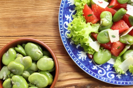 Close up of a broad beans salad with tomato and goat cheeseの写真素材
