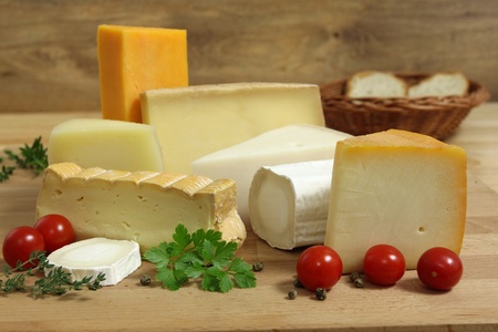Delicacies. Food composition - cheese varieties and vegetables.の写真素材