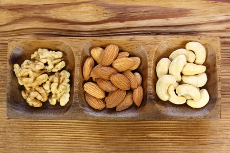 Assorted nuts almonds, cashews and walnuts in wooden bowl.の写真素材