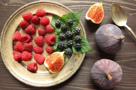Raspberry and blackberry on a silver platterの写真素材