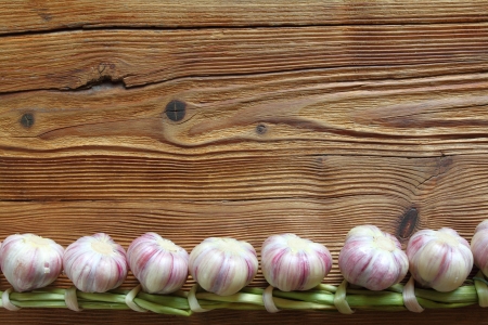 Braid of garlic on a wooden backgroundの写真素材