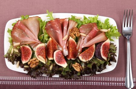 Salad with prosciutto ham, figs and pine nuts.の写真素材
