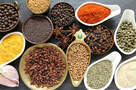 Spices in ceramic containers and metal bowlsの写真素材