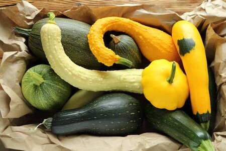 Courgettes and squashes stacked in a box on a paper.の写真素材