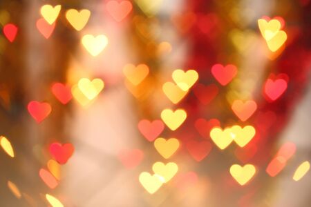 Bokeh blurred background of colored lights in the shape of heart.