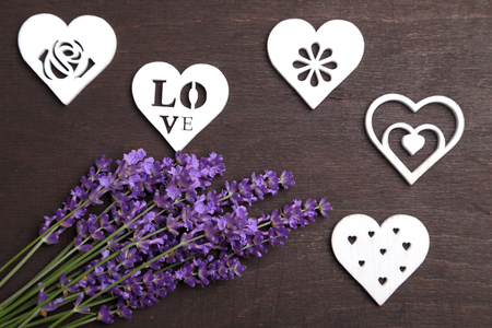 A bouquet of lavender and wooden heart on a dark background.の写真素材