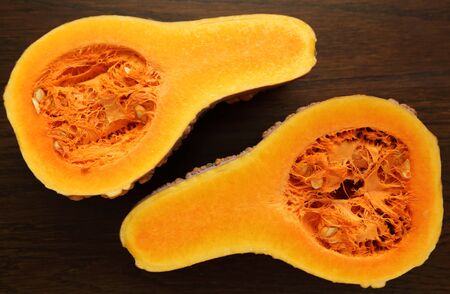 Fresh squash, muscat de Maroc, the cut in half on a wooden background.の写真素材