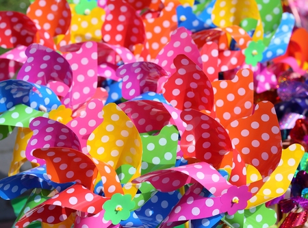 Collection of multicolored plastic pinwheel of different colors.