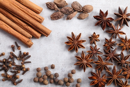 Brown aromatic spices on a gray ceramic background.