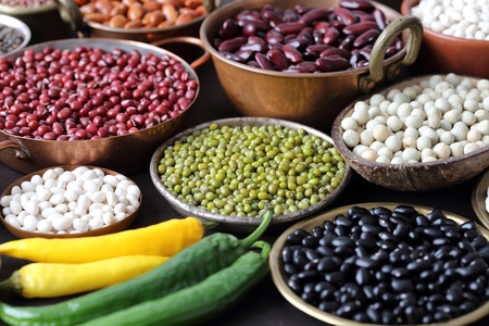 Beans, peas and lentils in metal bowls. Super food.