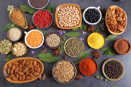 Aromatic spices and herbs in metal and ceramic bowls. Top view.の写真素材