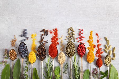 Aromatic herbs and spices on spoons. Top view, flat lay.の写真素材